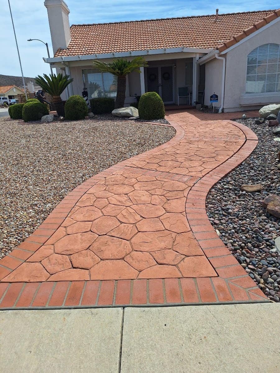 Beautiful stamped concrete walkway leading to a suburban home entrance.